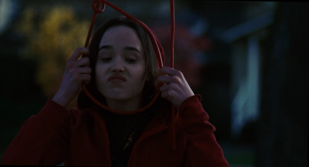 Screenshot of Ellen Page from Juno, pretending to hang herself from a tree